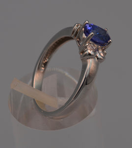 14K white gold ring with one center oval Tanzanite and four side diamonds