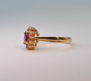 14K yellow gold ring with one center Ruby and 12 surrounding Diamonds