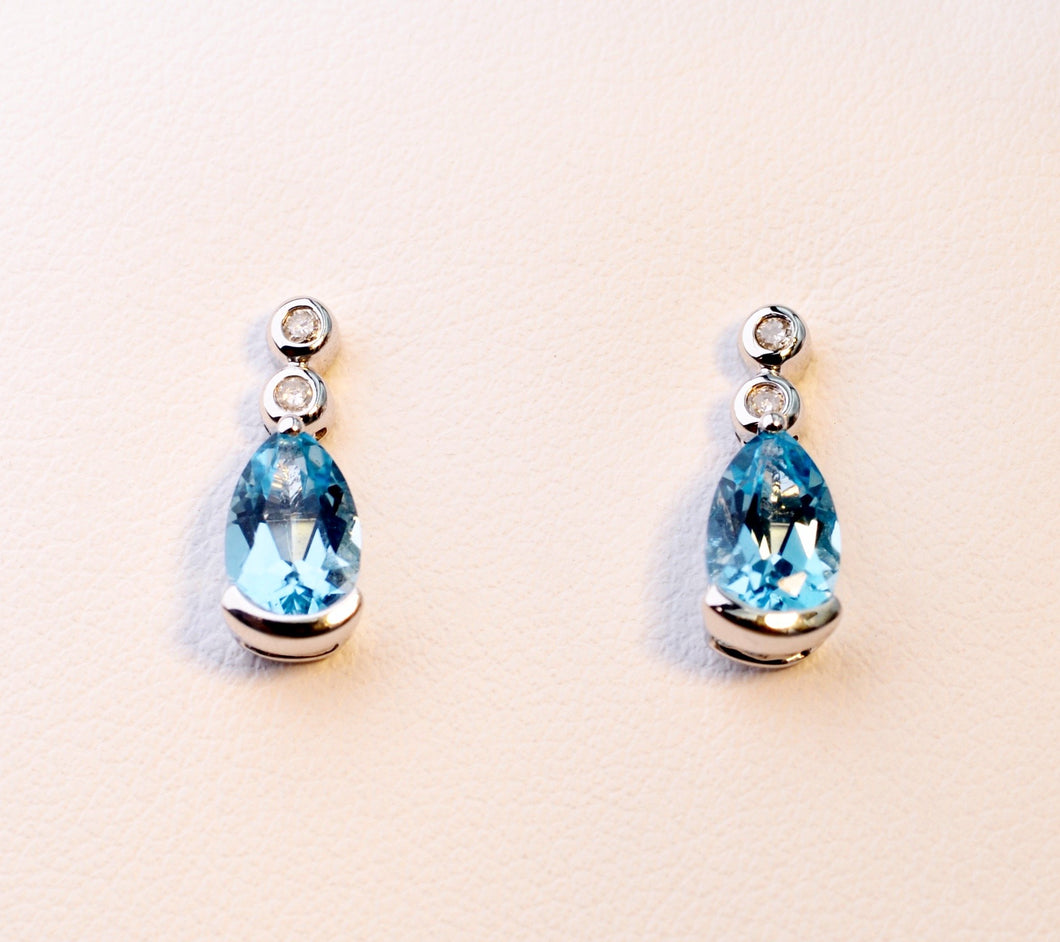 14K white gold post earrings with pear-shaped Blue Topaz drops